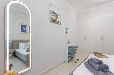 a bedroom with a mirror and a bed and a desk at Stunning 1 Bedroom Apartment in Dubai Marina in Dubai