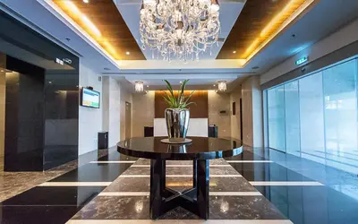 a dining room with a table and a chandelier at Stunning 1 Bedroom Apartment in Dubai Marina in Dubai