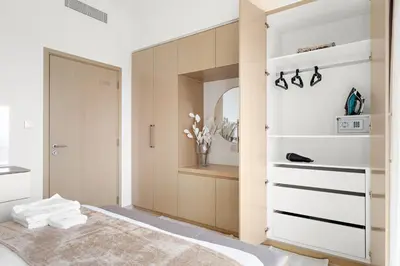 a bedroom with a closet with a bed and a mirror at Silkhaus High Floor Luxury 1 BDR with Stunning View in Dubai