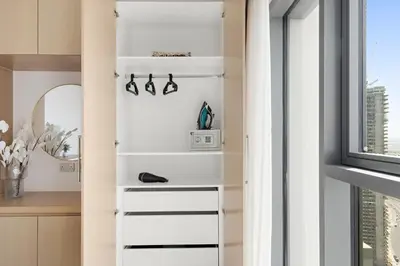 a white book shelf in a kitchen with a window at Silkhaus High Floor Luxury 1 BDR with Stunning View in Dubai