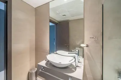 a bathroom with a toilet and a sink and a shower at Stunning High Floor Studio Apartment in BusinessBay in Dubai