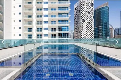 a swimming pool on the roof of a building at Stunning High Floor Studio Apartment in BusinessBay in Dubai