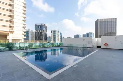 a swimming pool on the roof of a building at Stunning High Floor Studio Apartment in BusinessBay in Dubai