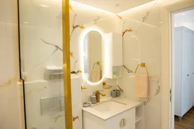 a bathroom with a sink and a mirror at Dubai Marina - 1BHK Modish Apartment in Dubai