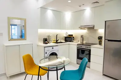 a kitchen with a glass table and two chairs at Dubai Marina - 1BHK Modish Apartment in Dubai