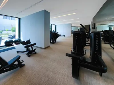 a gym with treadmills and exercise equipment in a building at Chic 2BD in Dubai Creek Harbour with Infinity Pool in Dubai