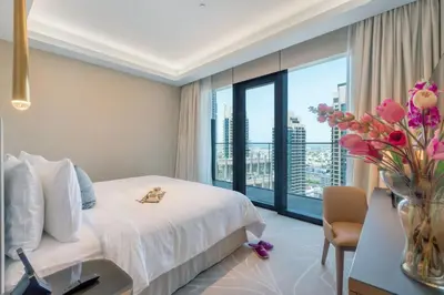 a hotel room with a bed and a vase of flowers at Dream Inn - Address Dubai Opera Residences in Dubai