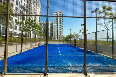 a tennis court in the middle of a city at WelHome - Fancy 1BR Apt at Dubai Hills near Dubai Hills Mall in Dubai