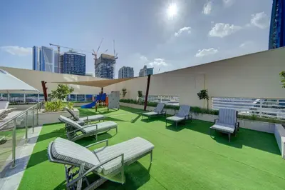 a group of chairs and tables on the roof of a building at Canal View l Hotel Studio l Great Amenities in Dubai