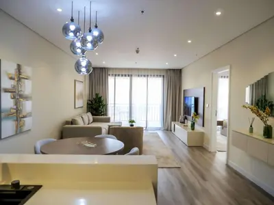 a living room with a table and a couch at Renovated 1BR Haven in 5 Star Resort in Dubai