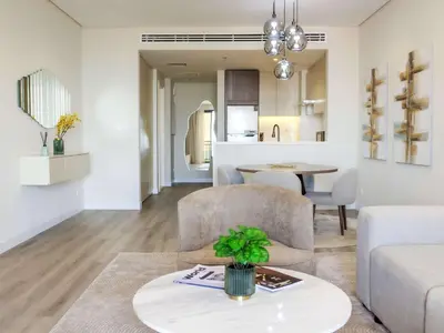 a living room with a couch and a table at Renovated 1BR Haven in 5 Star Resort in Dubai