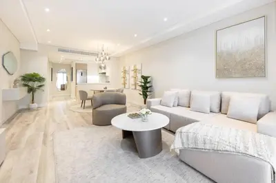 a living room with a couch and a table at Elegantly Renovated 1BR Apartment at 5 Star Resort in Dubai