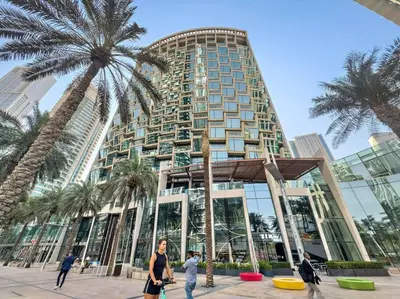 a tall building with palm trees in front of it at Iconic Burj View 1BR in Burj Vista Tower Near Shops & Metro in Dubai