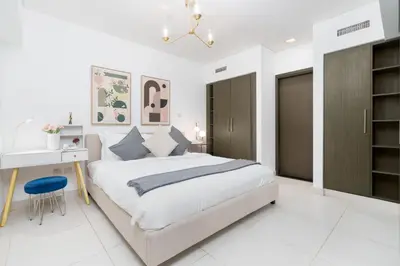 a white bedroom with a large bed and a desk at New Ultimate Stay 5 min walk from Dubai Mall Lofts Tower 5 pax in Dubai