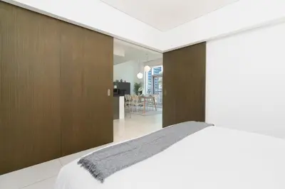 a bedroom with a bed and a dining room at New Ultimate Stay 5 min walk from Dubai Mall Lofts Tower 5 pax in Dubai
