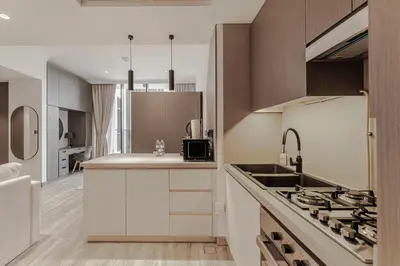 a kitchen with a sink and a stove top oven at Modern Studio with Pool View & Gym Access in Dubai