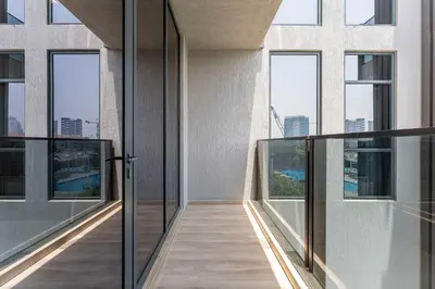 a hallway of a building with glass doors and windows at Modern Studio with Pool View & Gym Access in Dubai