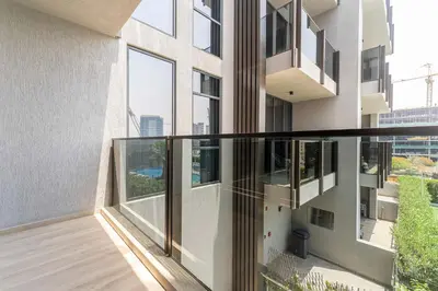 a balcony of a building with large windows at Modern Studio with Pool View & Gym Access in Dubai