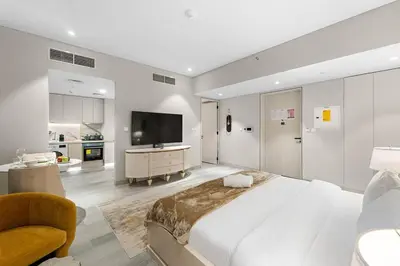 a large bedroom with a large bed and a television at FIRST CLASS Studio Luxe Serenity Retreat in Dubai
