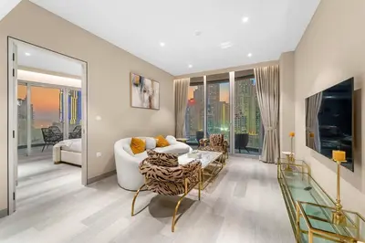 a living room with a couch and a table at Marina-View 1BR Escape Walk to Dining & Landmarks in Dubai