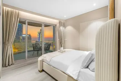 a bedroom with a bed and a large window at Marina-View 1BR Escape Walk to Dining & Landmarks in Dubai