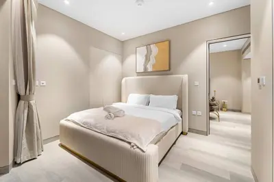 a bedroom with a white bed and a mirror at Marina-View 1BR Escape Walk to Dining & Landmarks in Dubai