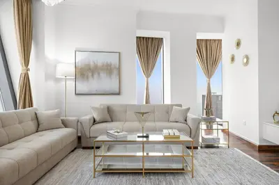 a living room with a couch and a coffee table at Luxury 4BR Flat, Downtown Dubai, Pool, Gym, PS5, Sleeps 11 Guests in Dubai