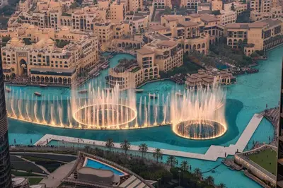 an aerial view of the water fountain in the city at Luxury 4BR Flat, Downtown Dubai, Pool, Gym, PS5, Sleeps 11 Guests in Dubai