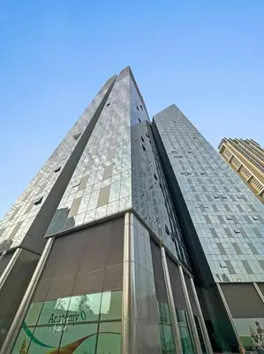 a tall building with glass windows in a city at FIRST CLASS 1BR Luxury Living in DIFC in Dubai