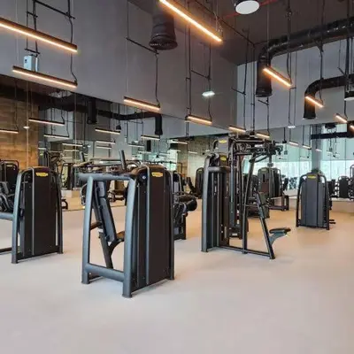 a gym with rows of exercise equipment on the floor at PrimeForte Walk to Dubai Mall in Dubai