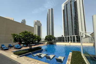 a large swimming pool in a city with tall buildings at Luxurious Living 3 Bedroom at Harbour Views in Dubai