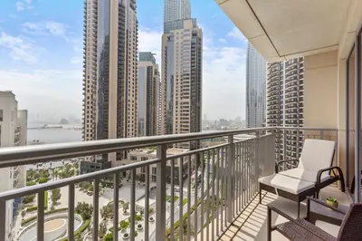 a balcony with a chair and a view of the city at Luxurious Living 3 Bedroom at Harbour Views in Dubai