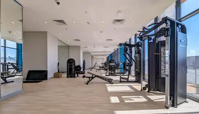 a gym with cardio equipment in a building at Azizi Riviera 46 - Cosy Studio in Dubai