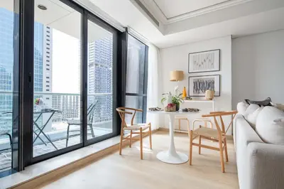 a living room with a table and chairs and a large window at Frank Porter - Goldcrest Views 2 in Dubai