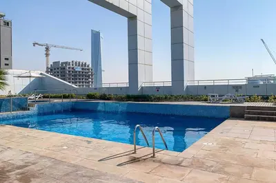 a swimming pool with blue water in a building at Frank Porter - Goldcrest Views 2 in Dubai