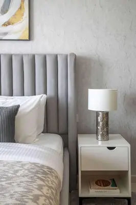 a bedroom with a bed and a lamp on a night stand at Frank Porter - Aykon City Tower C in Dubai