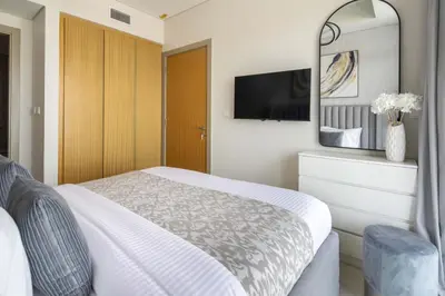 a bedroom with a bed and a tv on the wall at Frank Porter - Aykon City Tower C in Dubai