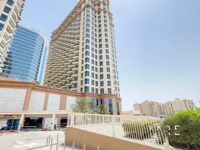 a tall building in the middle of a city at Rare Holiday Homes - Lake View - Near Me'aisem City Centre - The Crescent Tower A - Dubai Production City - R910 in Dubai