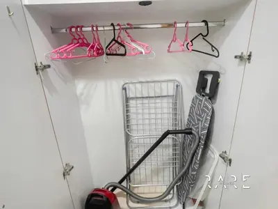 a garage with pink shoes and a cart in it at Rare Holiday Homes - Near The Lake - Lago Vista B - Dubai Production City - IMPZ - R2112 in Dubai