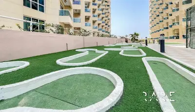 a grassy area with a number painted on it at Rare Holiday Homes - Near The Lake - Lago Vista B - Dubai Production City - IMPZ - R2112 in Dubai