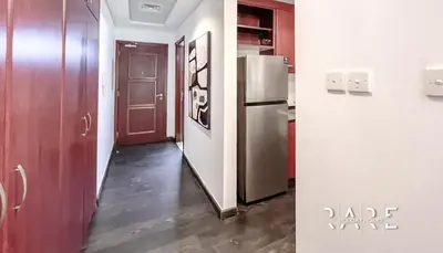 a kitchen with a stainless steel refrigerator in a room at Rare Holiday Homes - Mediterranean Cluster - Near Ibn Battuta Mall - Discovery Garden - Building# Med 49 - R411 in Dubai