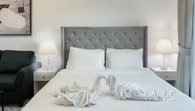 a bedroom with a bed with a swan decoration on it at Rare Holiday Homes - Mediterranean Cluster - Near Ibn Battuta Mall - Discovery Garden - Building# Med 49 - R106 in Dubai