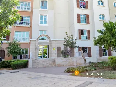 an apartment building with an orange light in front of it at Rare Holiday Homes - Mediterranean Cluster - Near Ibn Battuta Mall - Discovery Garden - Building# Med 49 - R106 in Dubai