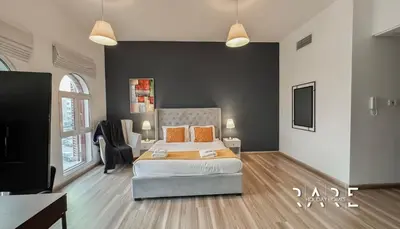 a bedroom with a bed and a tv in it at Rare Holiday Homes - Mediterranean Cluster - Near Ibn Battuta Mall - Discovery Garden - Building# Med 79 - R203 in Dubai