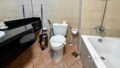 a bathroom with a toilet and a bath tub at Rare Holiday Homes - Mediterranean Cluster - Near Ibn Battuta Mall - Discovery Garden - Building# Med 100 - RG13 in Dubai