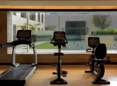 a gym with two exercise bikes in front of a window at Downtown Studio - Cour Jardin in Dubai