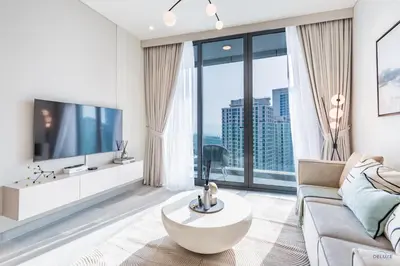 a living room with a couch and a large window at Waterfront Living 2BR Apartment in Marina Star, Dubai Marina by Deluxe Holiday Homes in Dubai