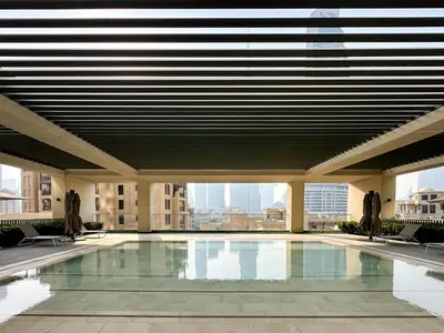 a swimming pool in a building with a large ceiling at Breathtaking Burj View, Sky High Luxury 2BR Apartment by 2nd Best Home in Dubai