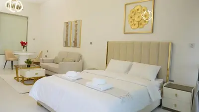 a bedroom with a large bed with two towels at Dimorelux l Club Vista Mare l Five Palm Jumeirah in Dubai