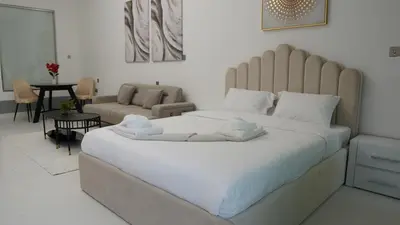 a bedroom with a large bed and a living room at Dimorelux l Club Vista Mare l Five Palm Jumeirah in Dubai